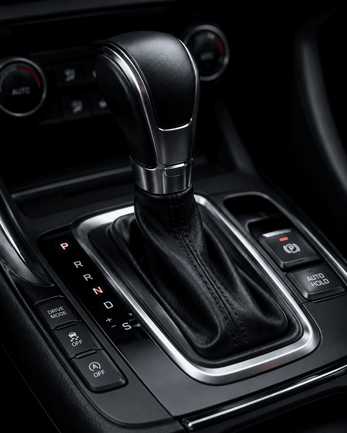 Automatic transmission gear selector in a vehicle's centre console, showing the P R N D S positions